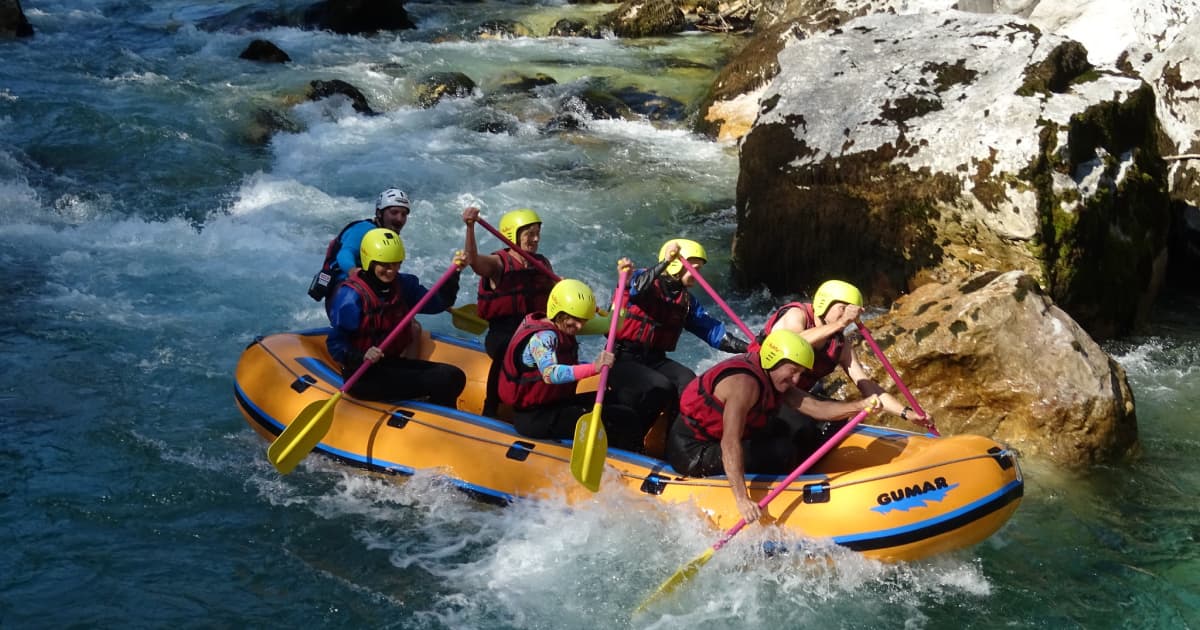 group of travelers rafting down Sava river in Slovenia