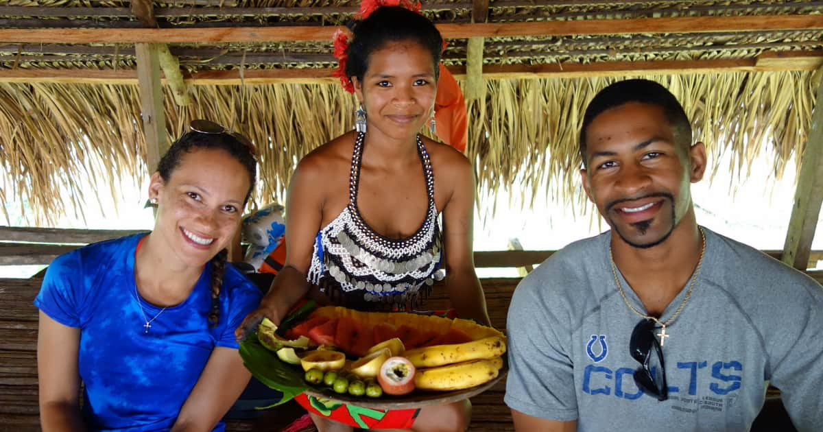 Local villager in Angor Watt delivering food on a platter to 2 travelers