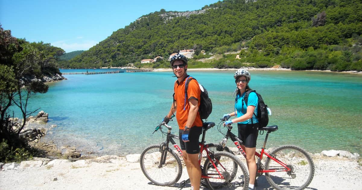 biking couple stopping to admire the lakeside views