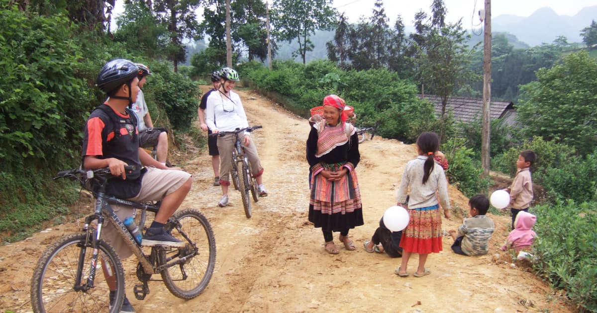 Cyclists chatting with local villagers