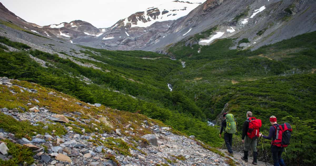 group of travelers backpacking through mountains