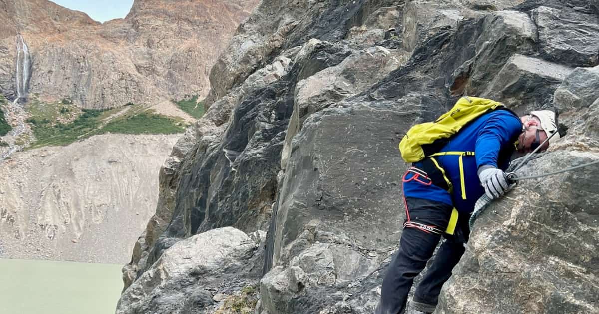 adventure traveler climbing a rock face