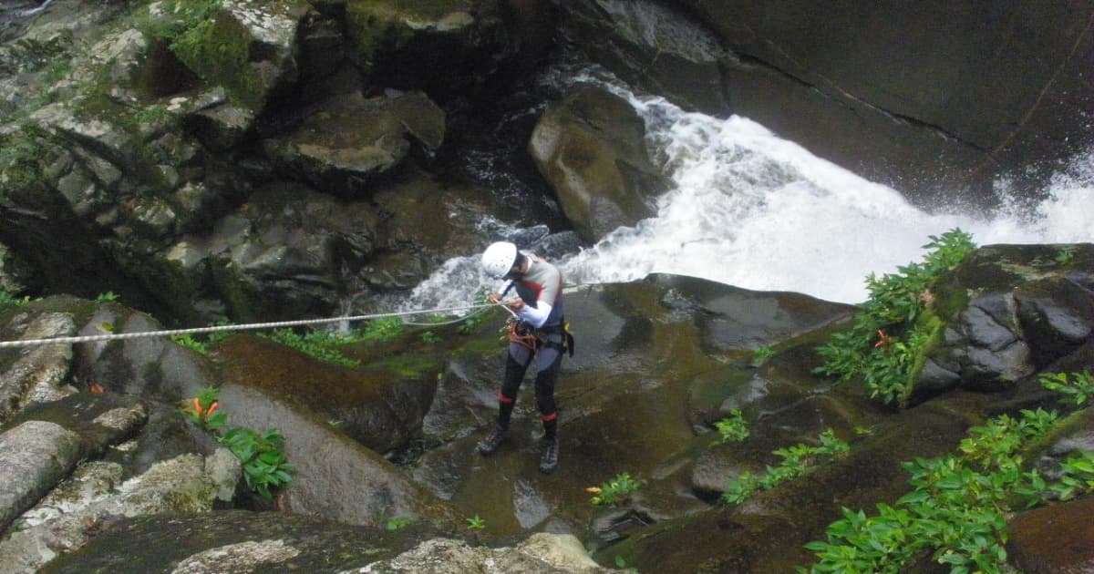 rappelling down a waterfall