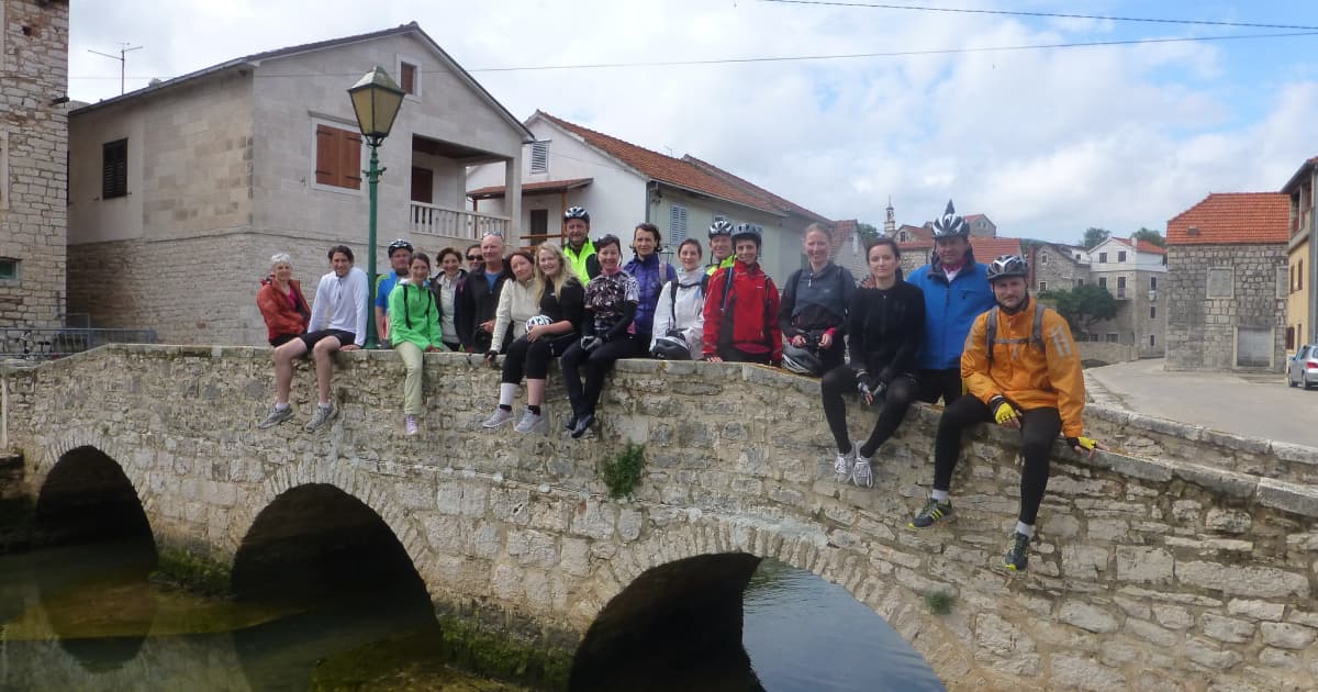 cyclists sitting on a bridge in Dubrovnik