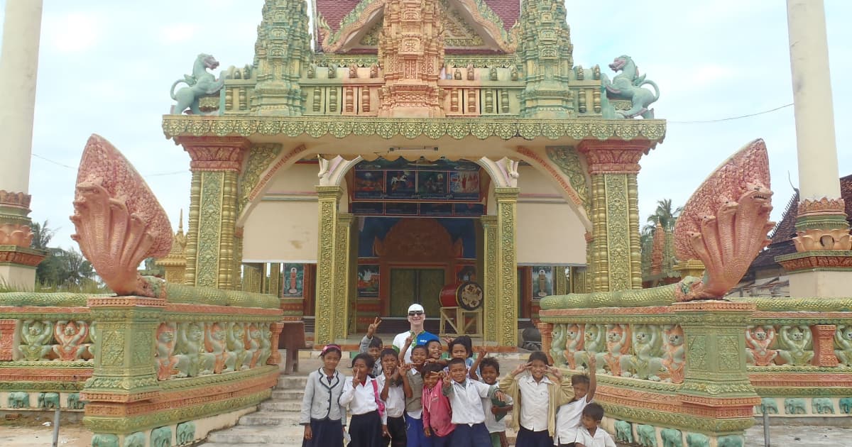 Traveler with a group of local children