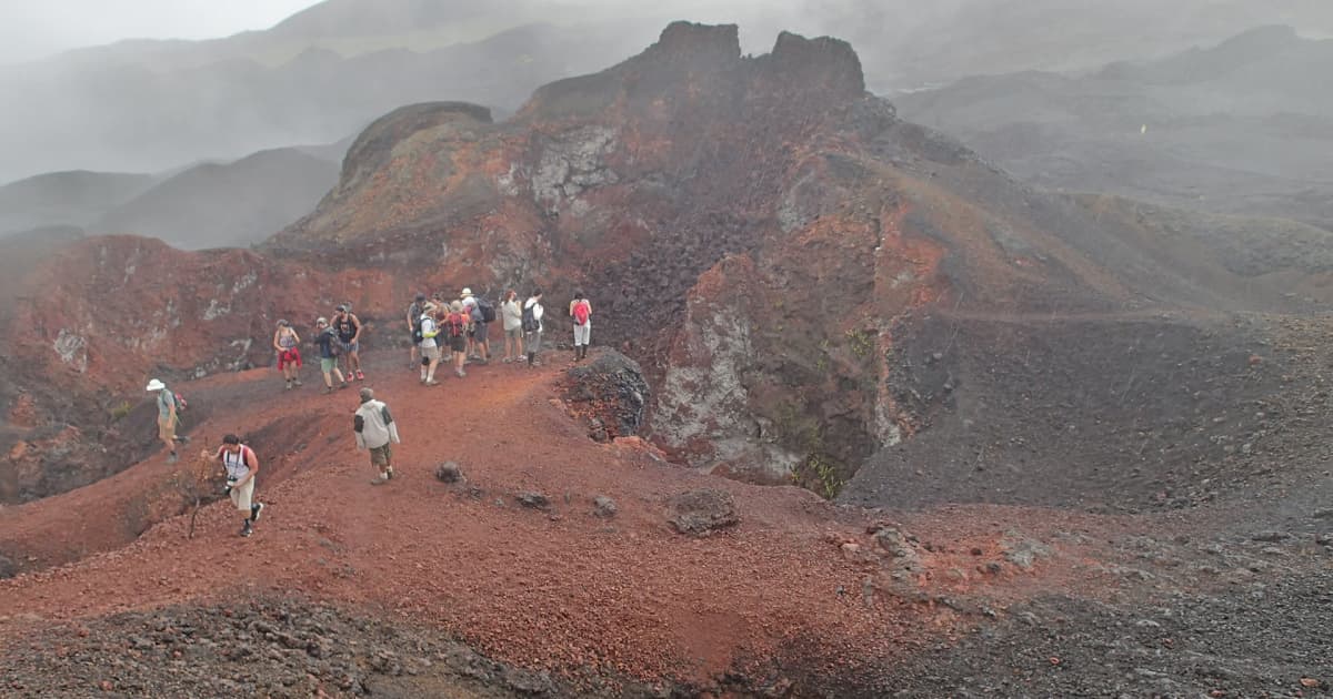 travelers trekking on a volcano at the Galapagos islands