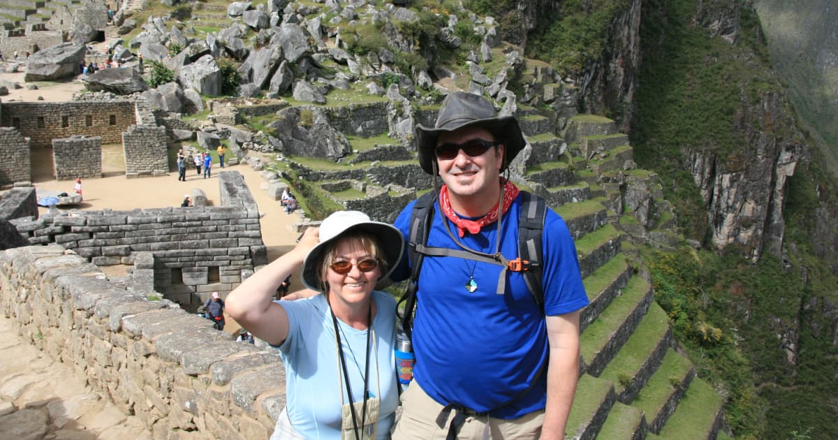 Couple at Machu Picchu wearing hat and sunglasses