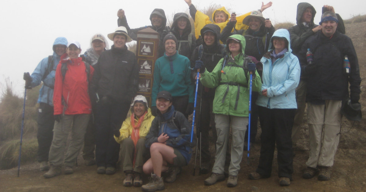 Group of travelers in rain gear at Machu Picchu