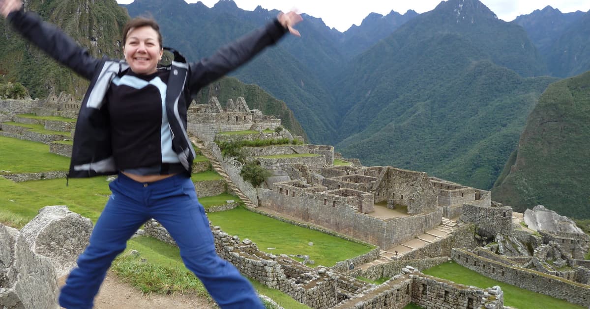 Trish Sare in a starfish post in front of Machu Picchu