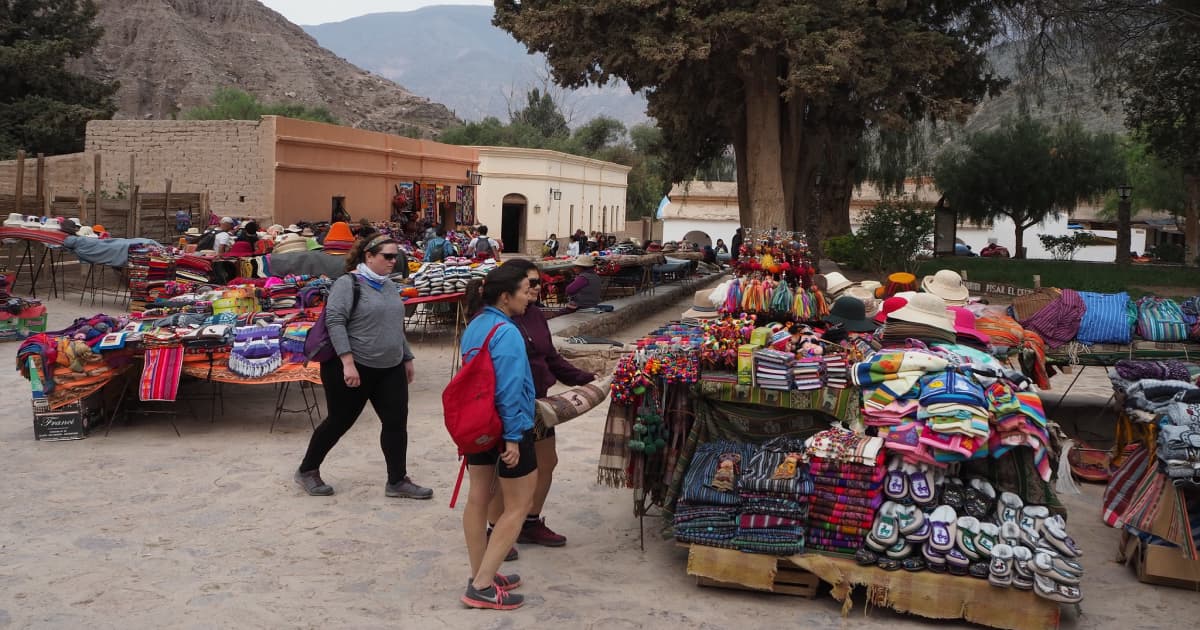 Travelers visiting the stalls of a Moroccan craft fair