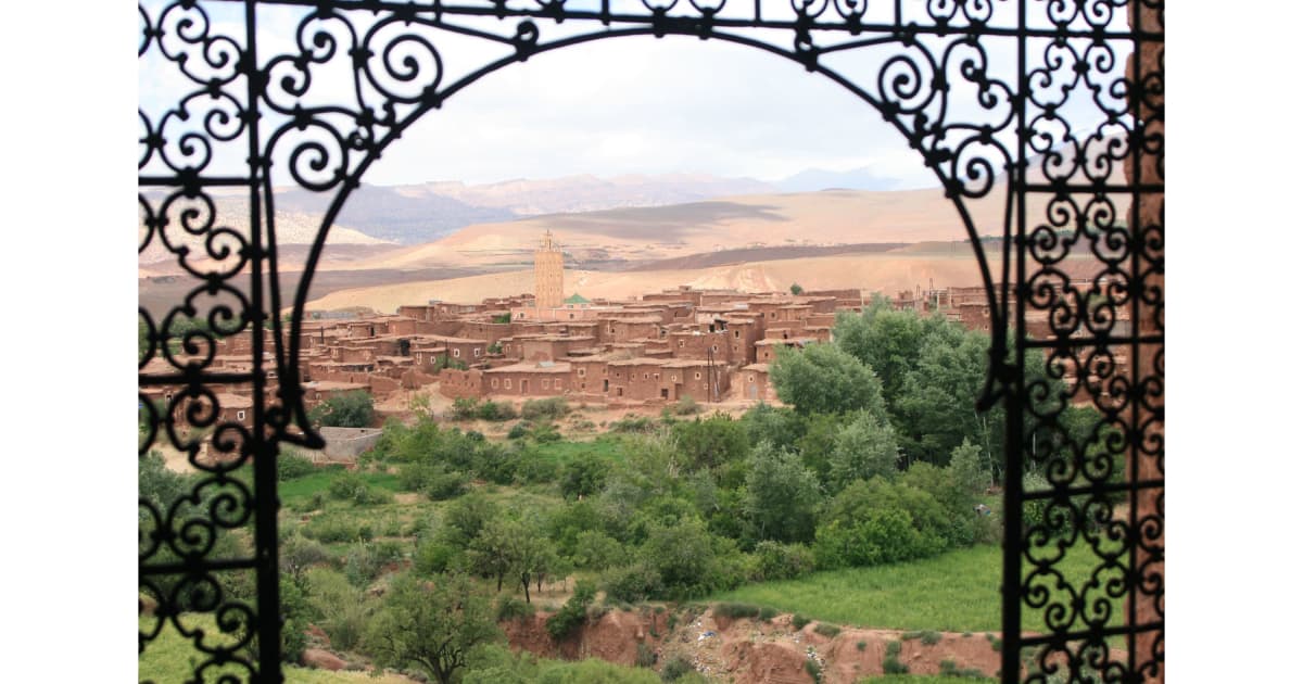 looking through a metal gate at the Moroccan landscape