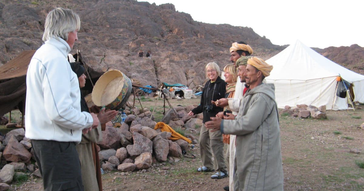 Moroccan local villagers greeting a passing traveler
