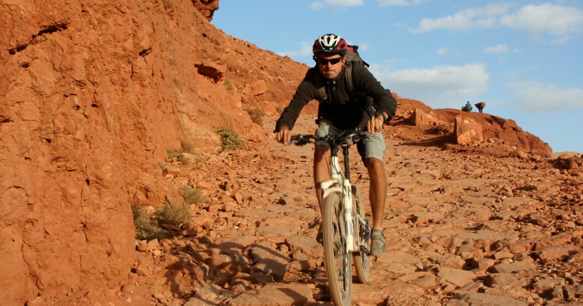 Riding down the rugged terrain of the high atlas mountains on a bicycle