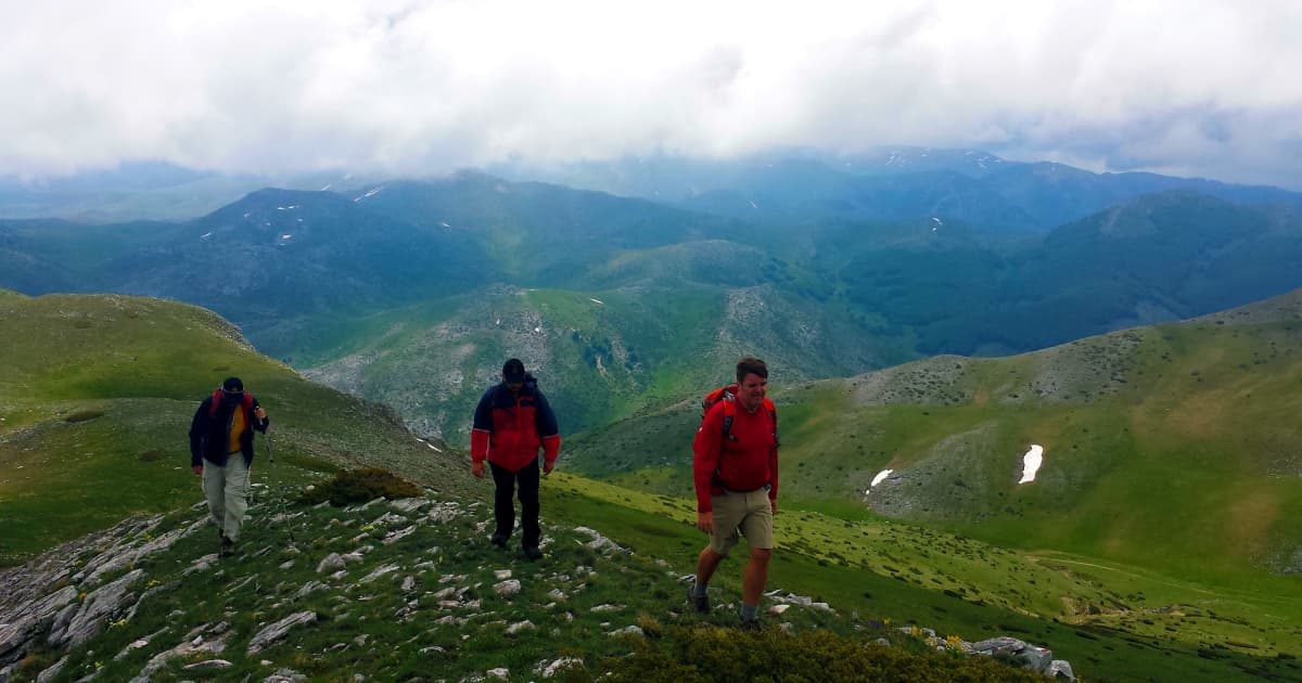 a group of tourists hiking over a scenic mountain