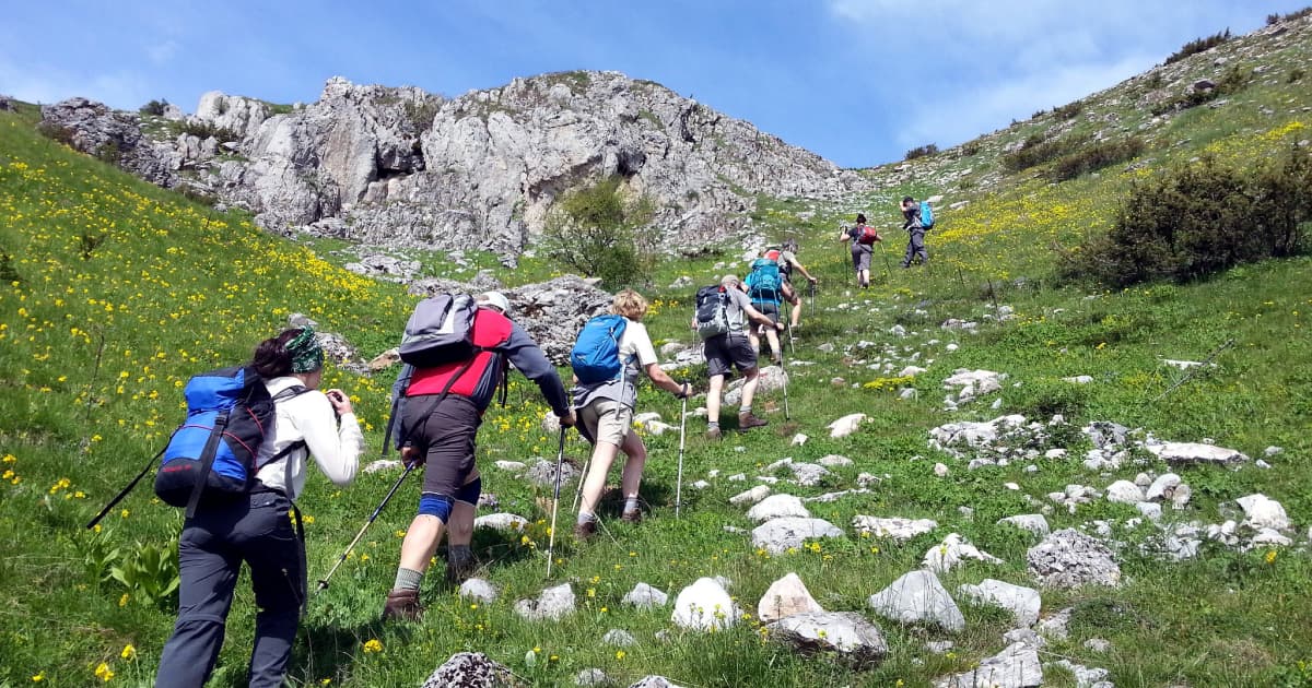 a group of tourists trekking a mountain trail in North Macedonia