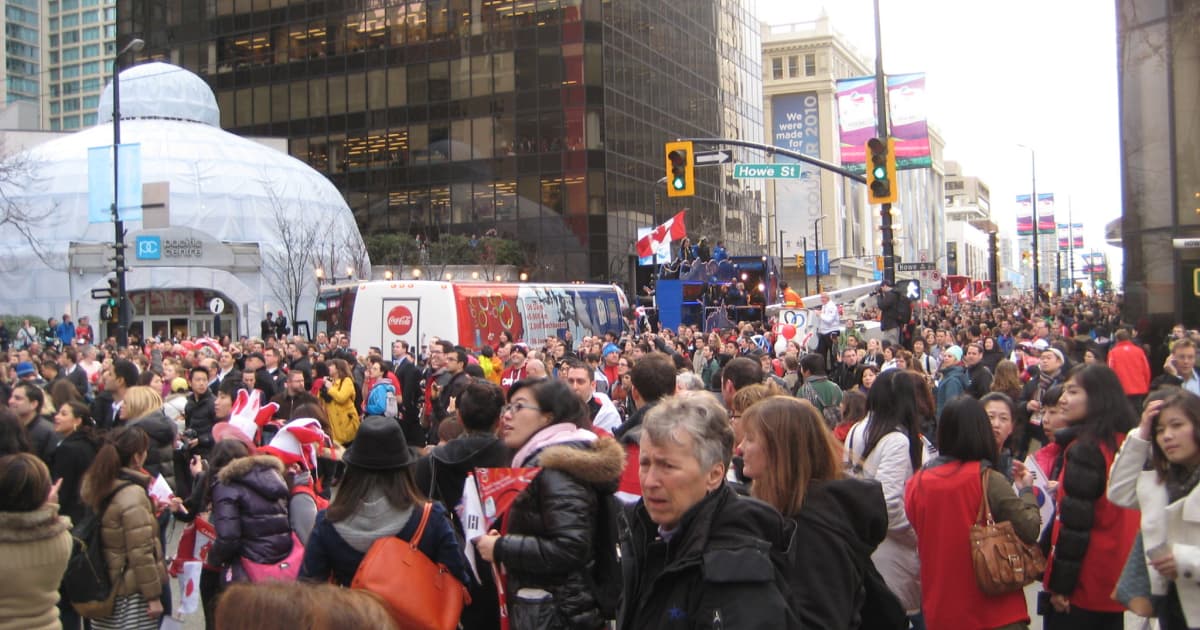 crowds of tourists gathering on a busy city street