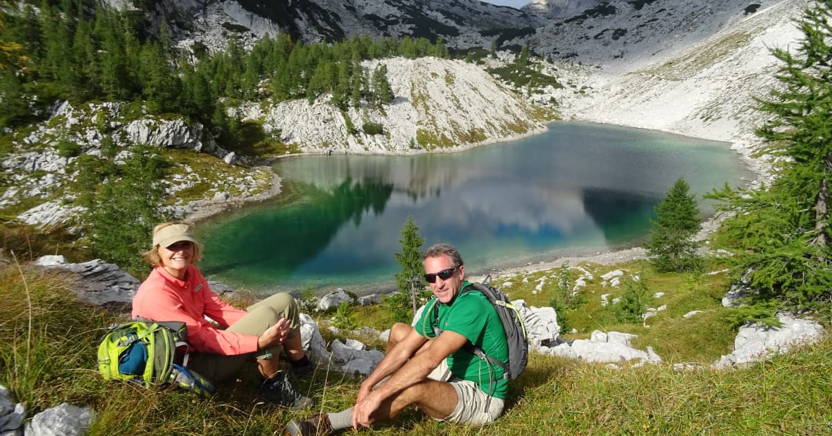 hikers relaxing by a lake in slovenia