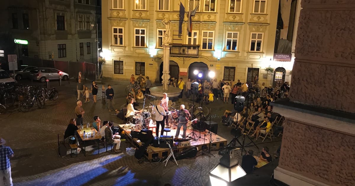 a band playing in the streets at nightime in ljubljana