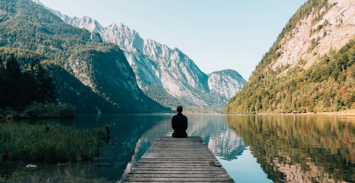 Traveler sitting by lake