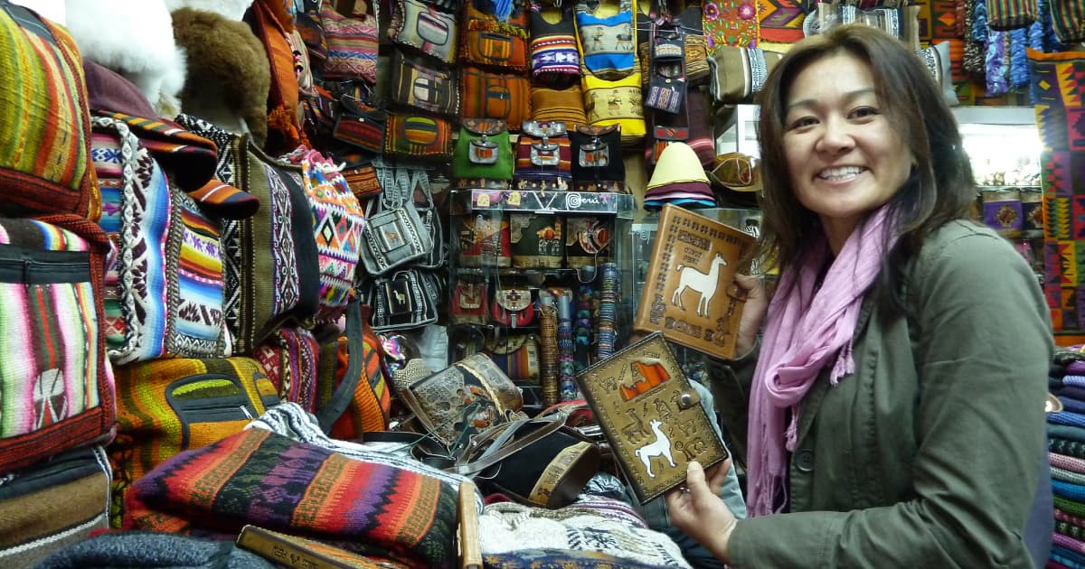 visitor in a traditional Peru store looking at handmade crafts and clothes