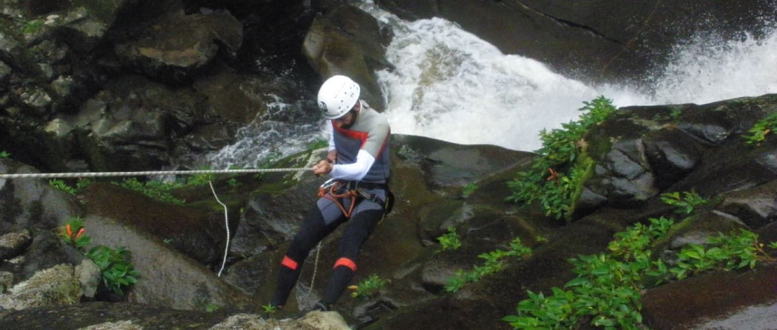 Rapelling down the side of a canyon