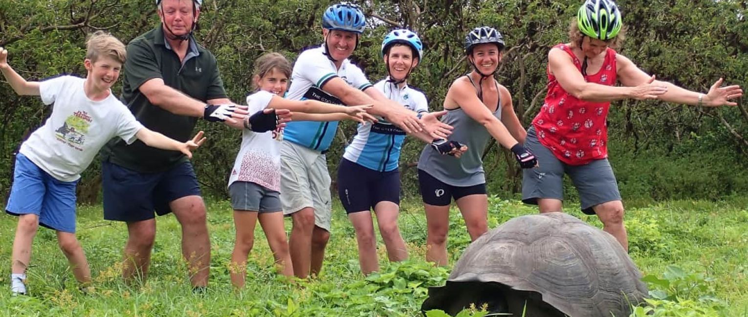 Family with a large tortoise at the Galapagos islands