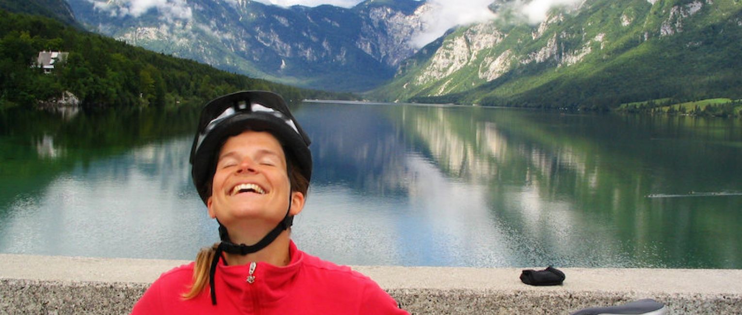 Cyclist Standing In Front Of Slovenia Lakes