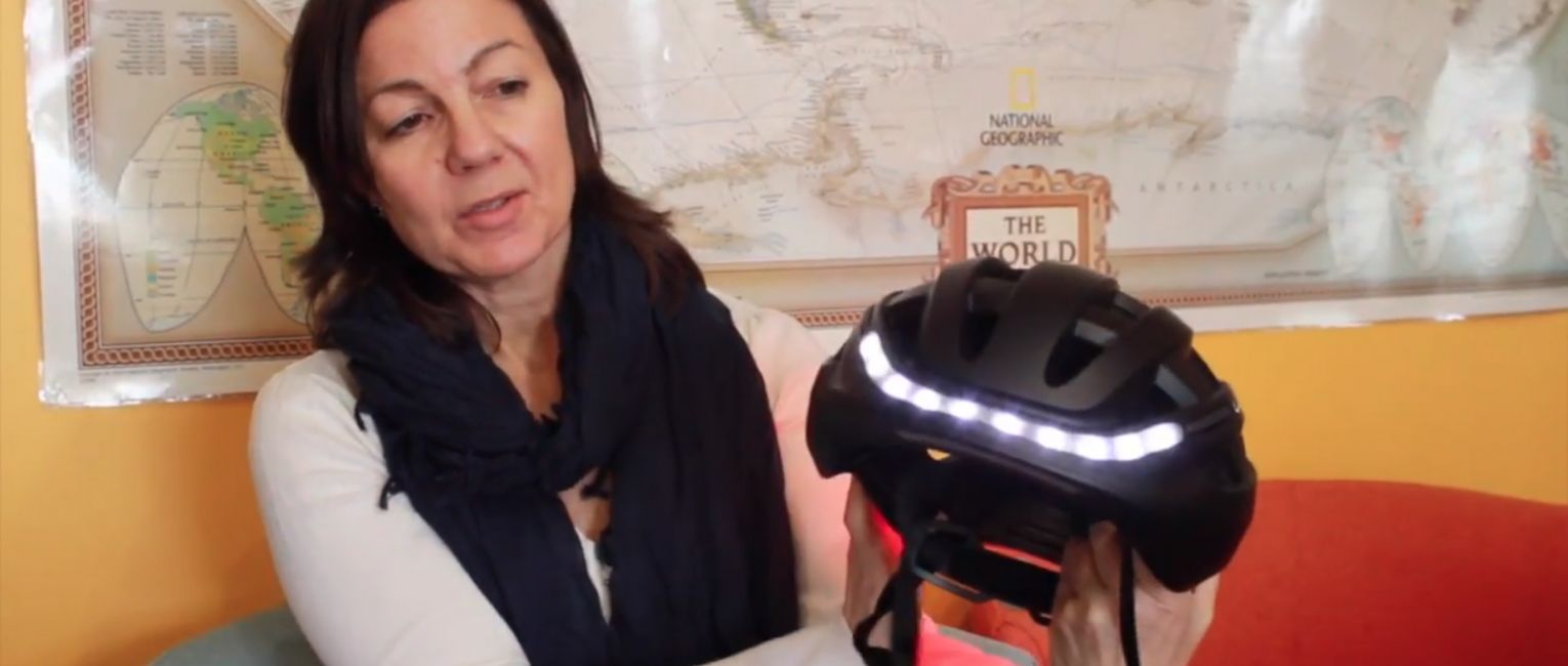 Trish Sare holding the Lumos kickstarter cycling helmet