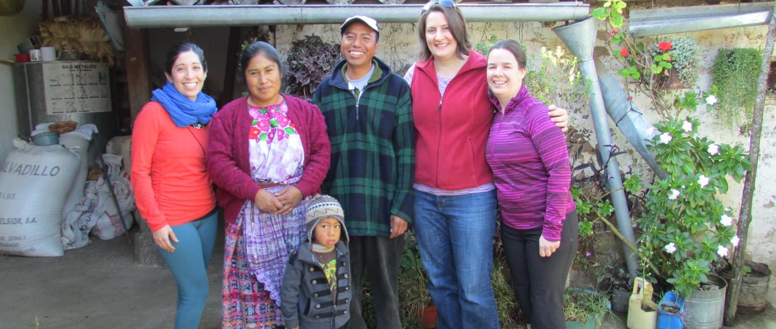 Meg with a family at a homestay accommodation