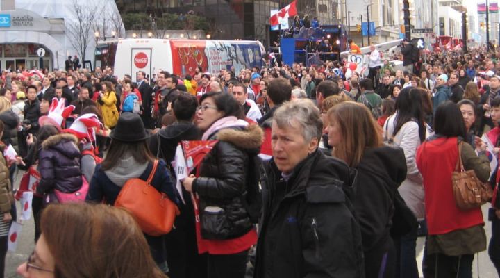 Crowds of people gathering on a city street