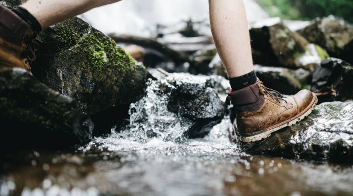 hiker walking through shallow lake