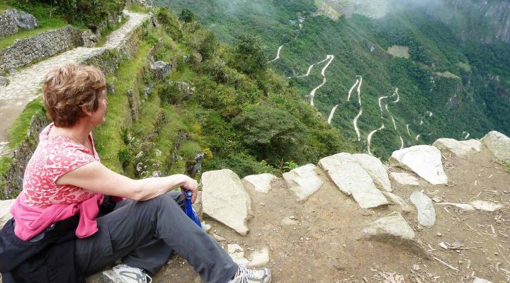 Traveler sitting and overlooking Machu Picchu Landscape
