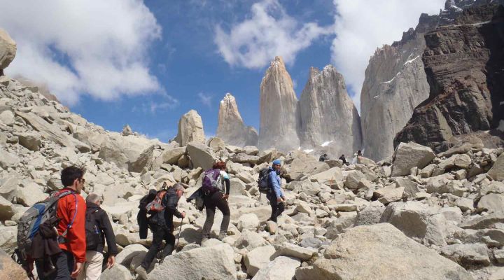 Groups of tourists hiking stone rocks in Torres Del Paine, Chile