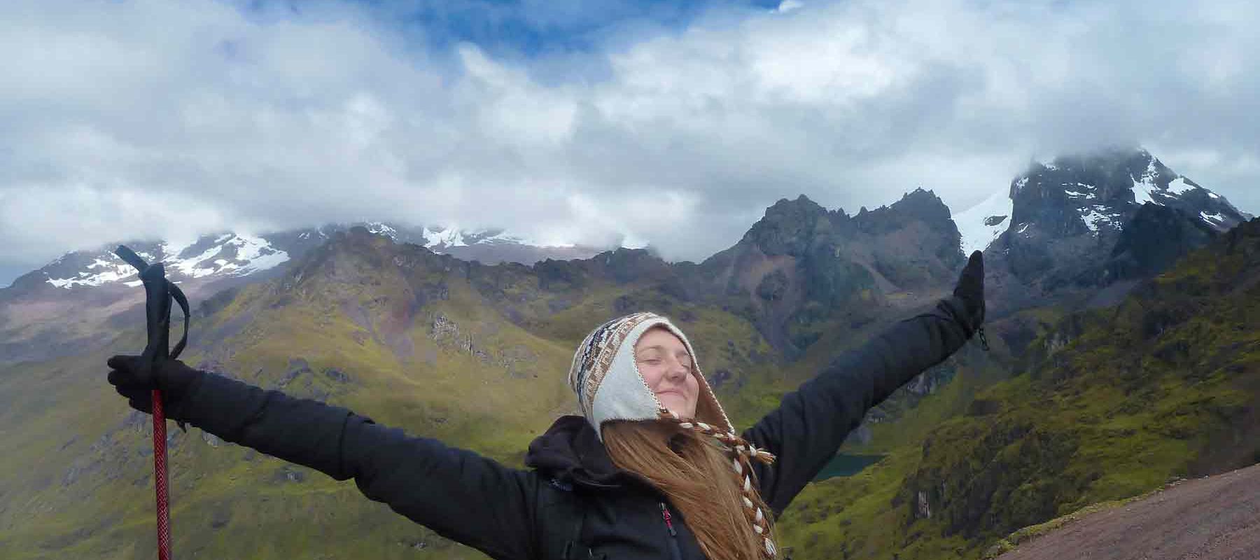 Traveler celebrating in front of Mountains Peru