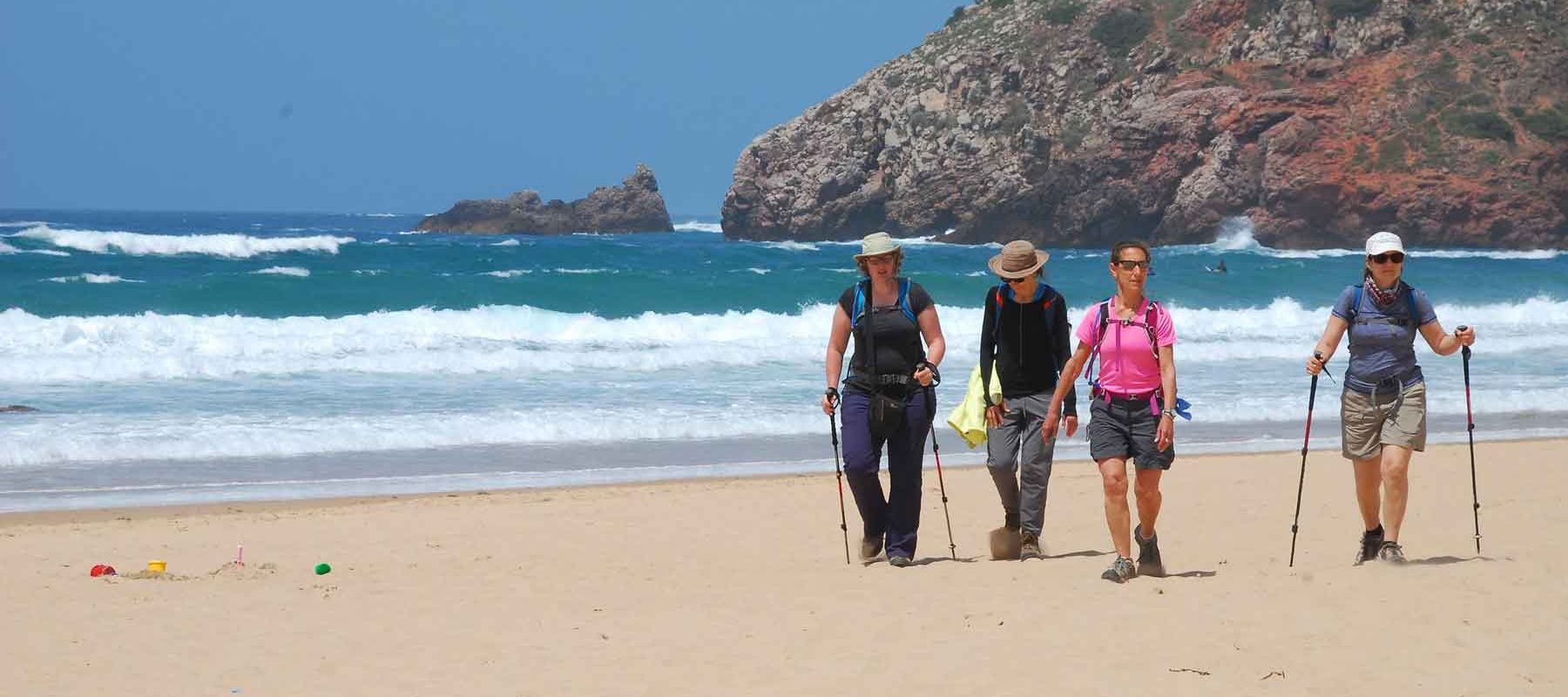 Travellers Hiking A Beach In Portugal