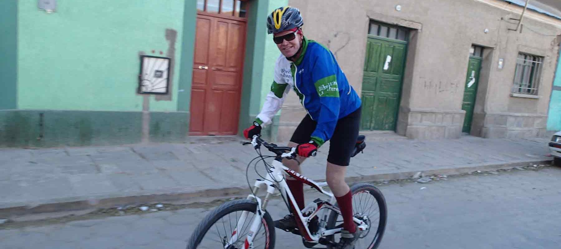 Tour guide biking the streets of Bolivia