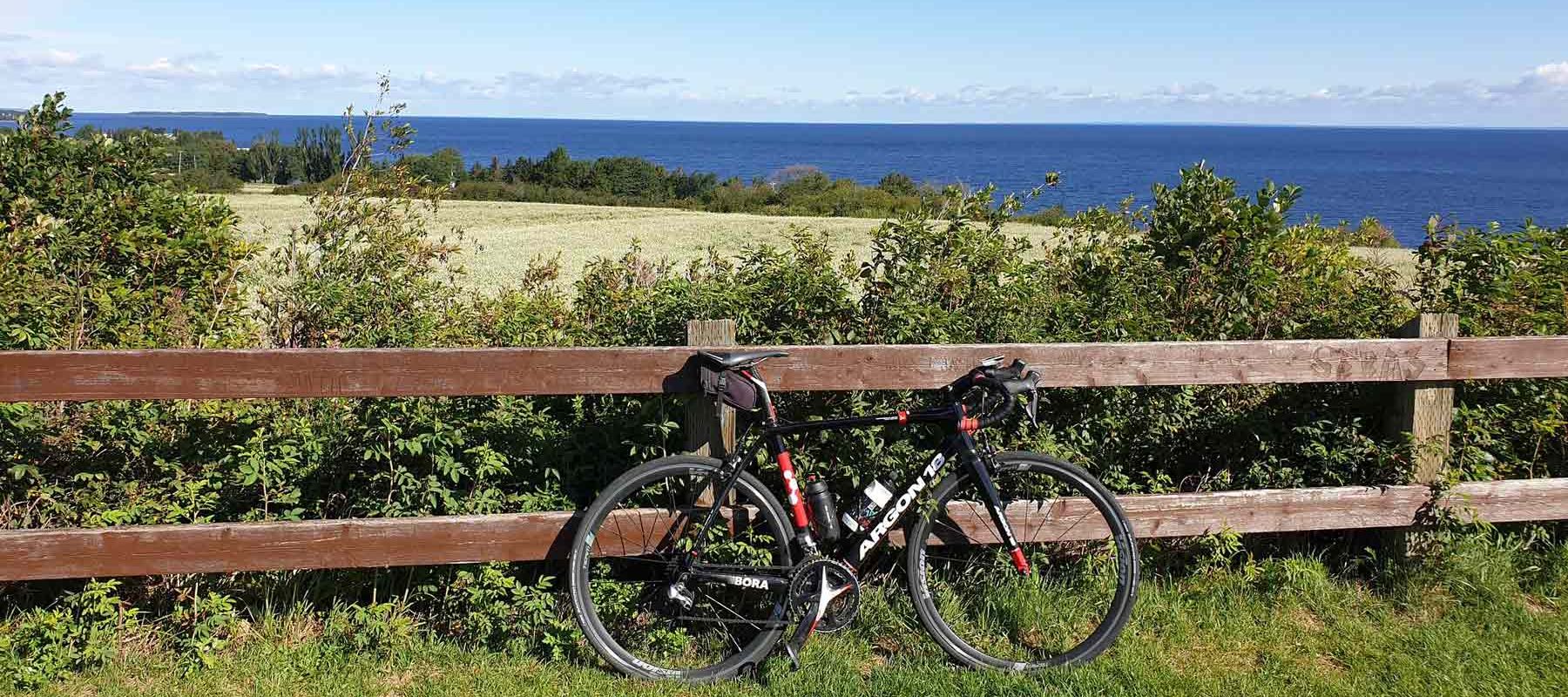 Bike set against fence as tourist takes cycling break in Lac Saint Jean Quebec