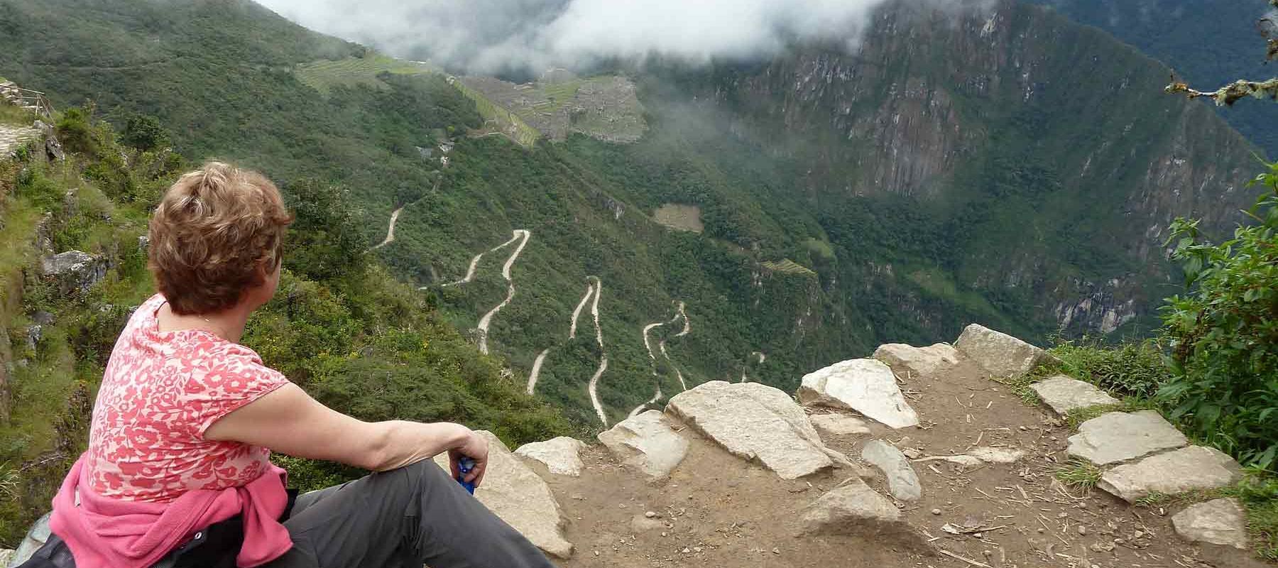 Tourist overlooking mountains of Machu Picchu