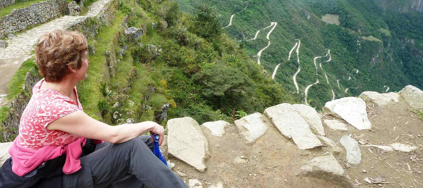 Traveler sitting and overlooking Machu Picchu Landscape