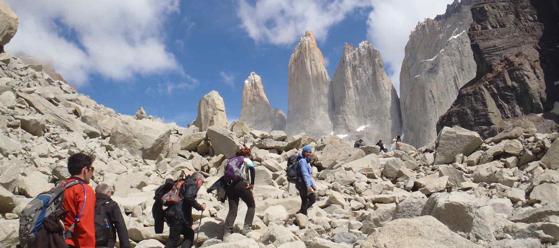 Groups of tourists hiking stone rocks in Torres Del Paine, Chile